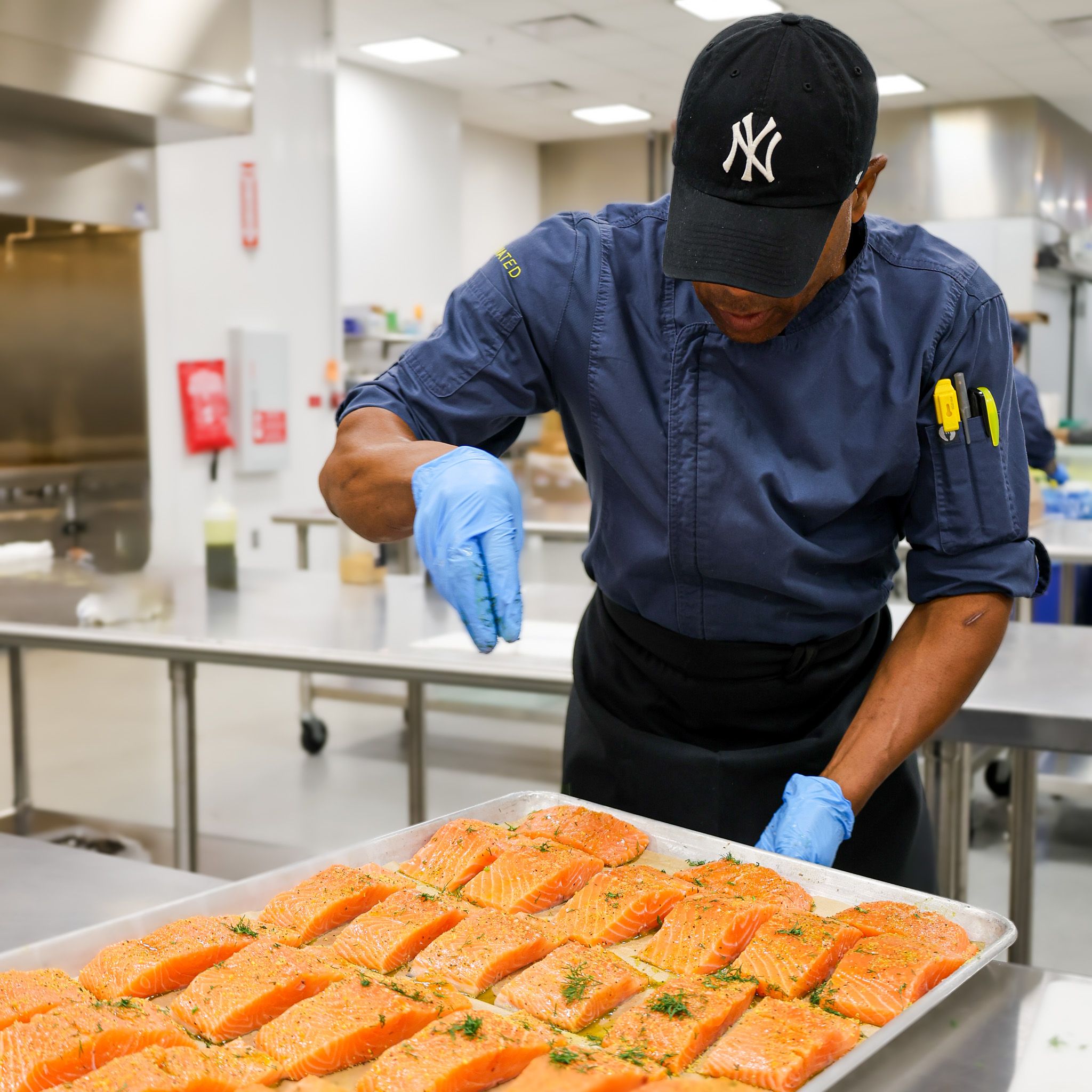 Javits staff member preparing food in the kitchen at Javits Center.